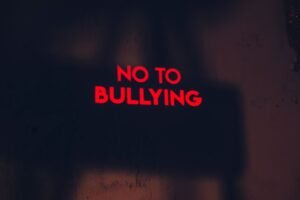 Harassment & Sexual Misconduct in Higher Education (OfS Condition E6) - A compelling image with the message 'No to Bullying' in bold red text on a dark background.