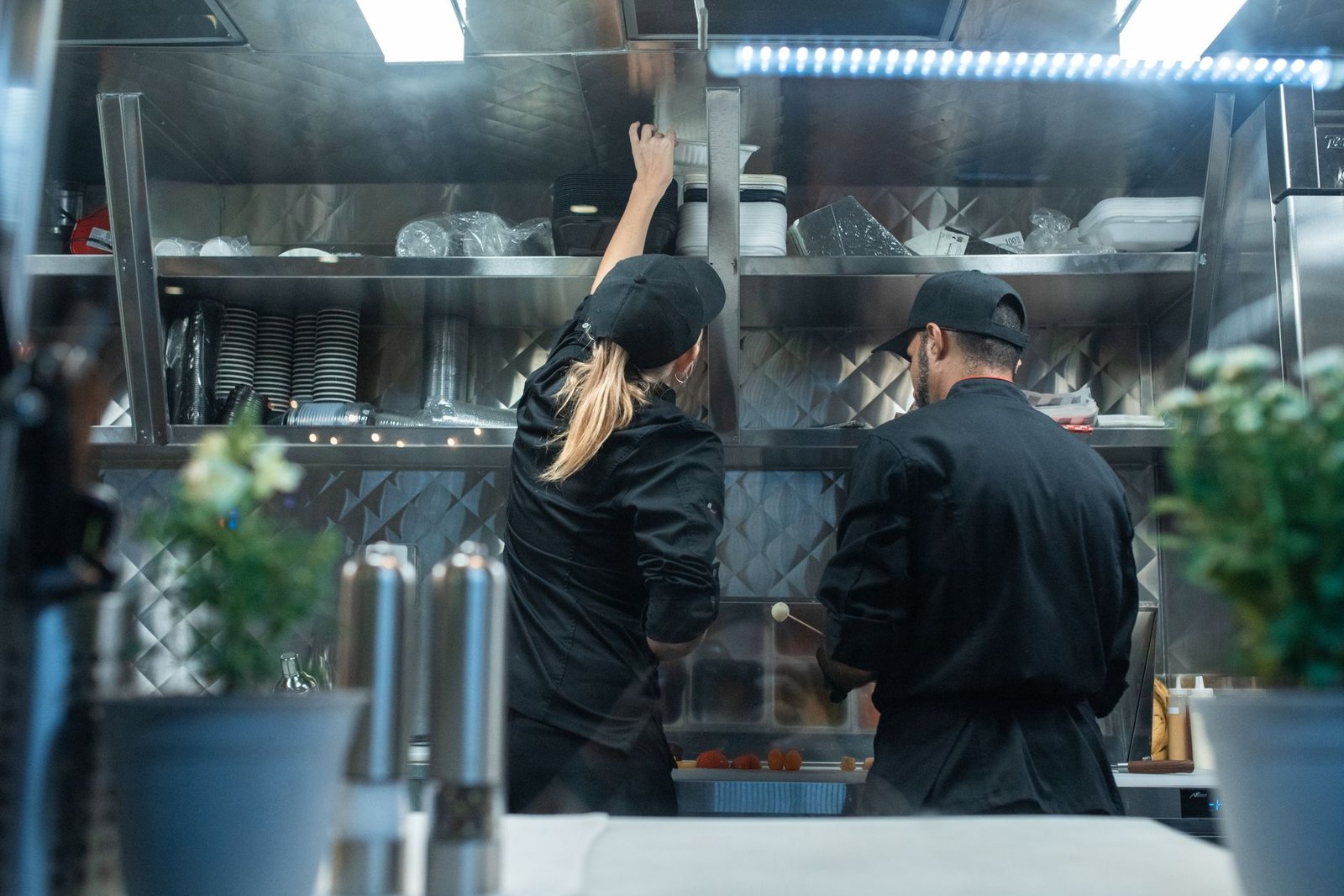 Working in the Service Industry Certification - Two chefs working together in a commercial kitchen, preparing food.