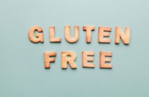 Food Allergies and Intolerances Certificate - Gluten-free cookie letters form a phrase on a turquoise background, ideal for allergy awareness.