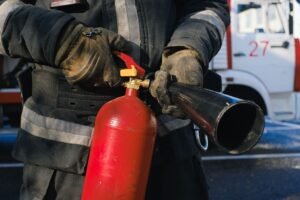 Fire Marshal Certification - Firefighter in uniform holding a fire extinguisher, emphasizing safety and emergency readiness.