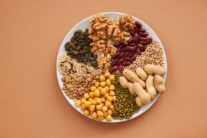 Food Allergen Awareness Certification - Top view of nuts, beans, and seeds on a plate, ideal for healthy dining themes.