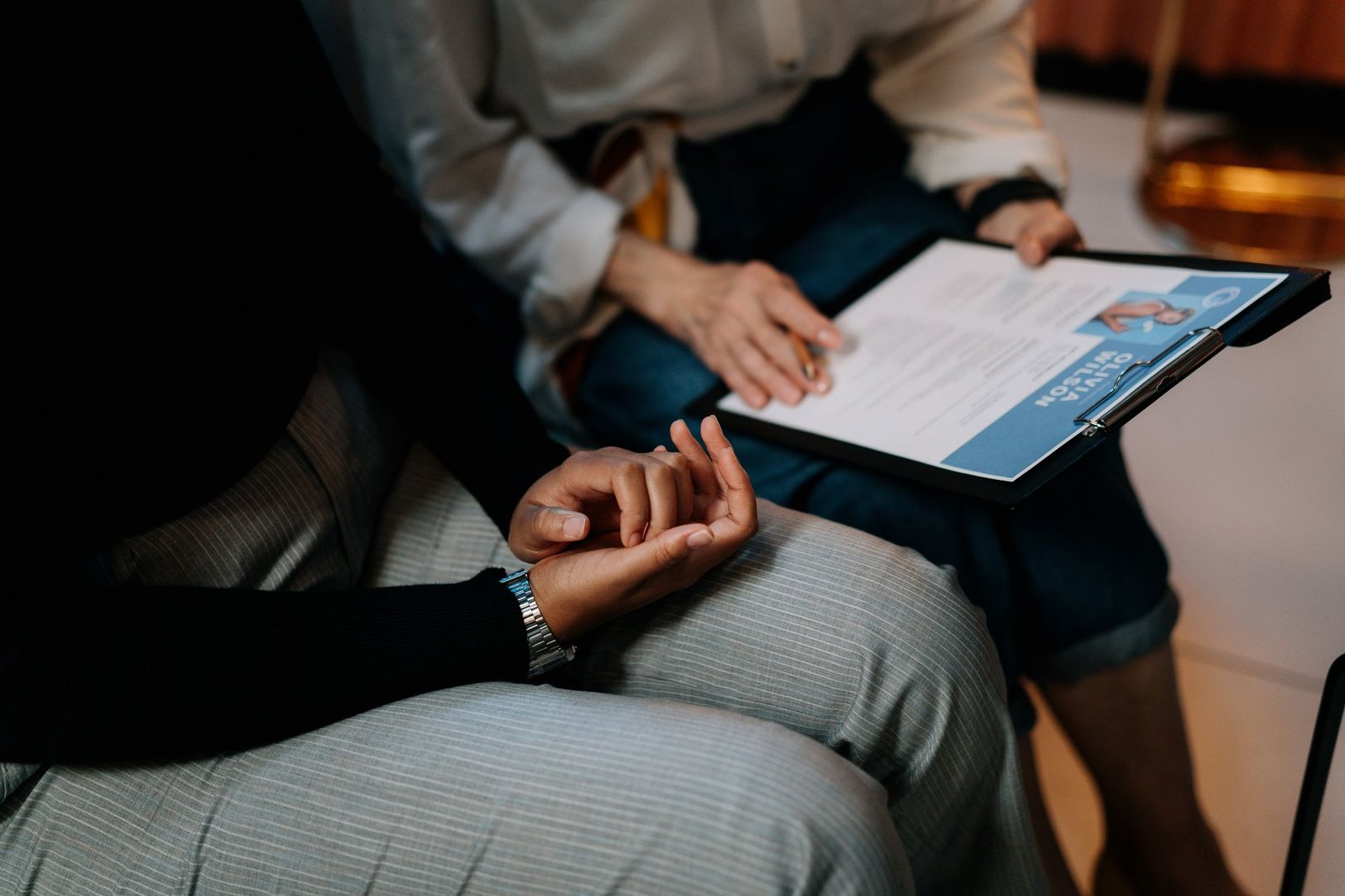 Safer Recruitment Certification - Two professionals reviewing a resume in an office setting, focused on teamwork.