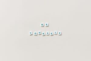 Building Your Confidence and Self-Esteem Certification - Motivational phrase "Be Yourself" spelled with letter tiles on a white background.