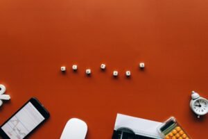 Introduction to Reddit Marketing Certification - Creative still life with financial tools and the word 'MARKETS' on an orange background.