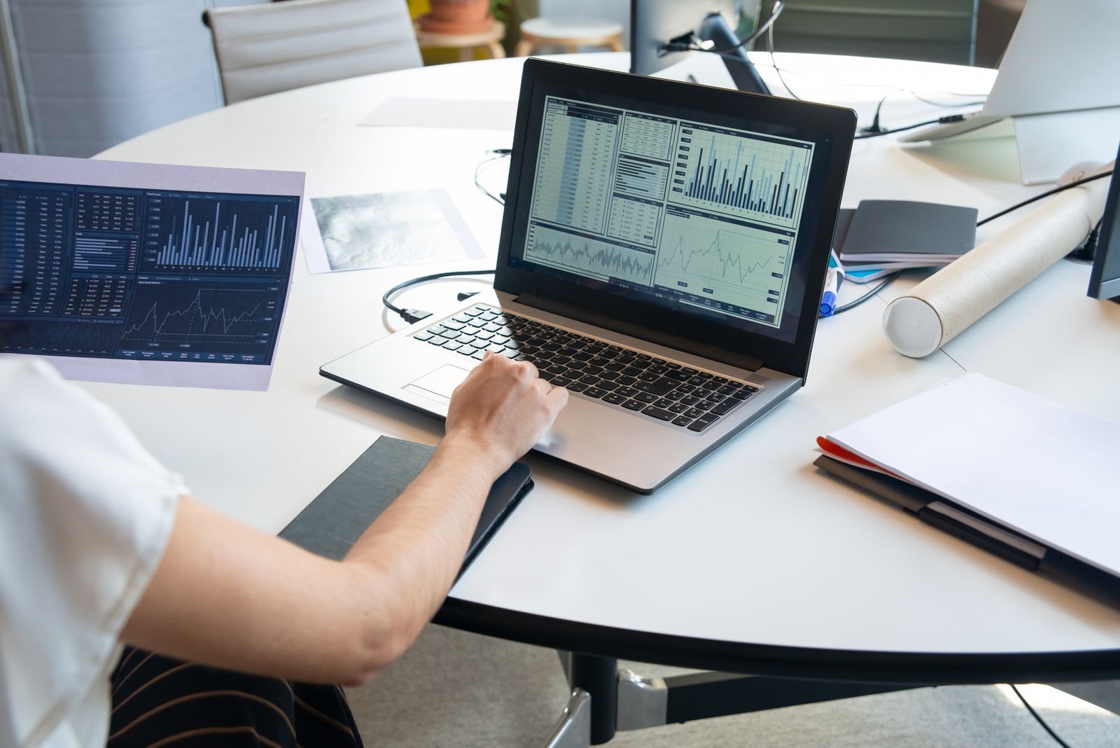 Data Analysis Certification - Business person evaluating financial charts on a laptop in a modern office setting.