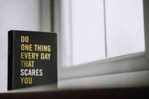 Make an Impression Every Time Certification - Rectangular shaped book with printed title on black hardcover on windowsill in house in daytime