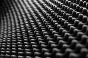 Noise and Vibration Awareness Certification - Close-up view of textured soundproof foam in black and white, showcasing its detailed pattern.