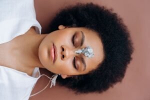 Introduction to The Power of the Mind Certification - Woman practicing meditation with healing crystal on forehead, promoting wellness and relaxation.