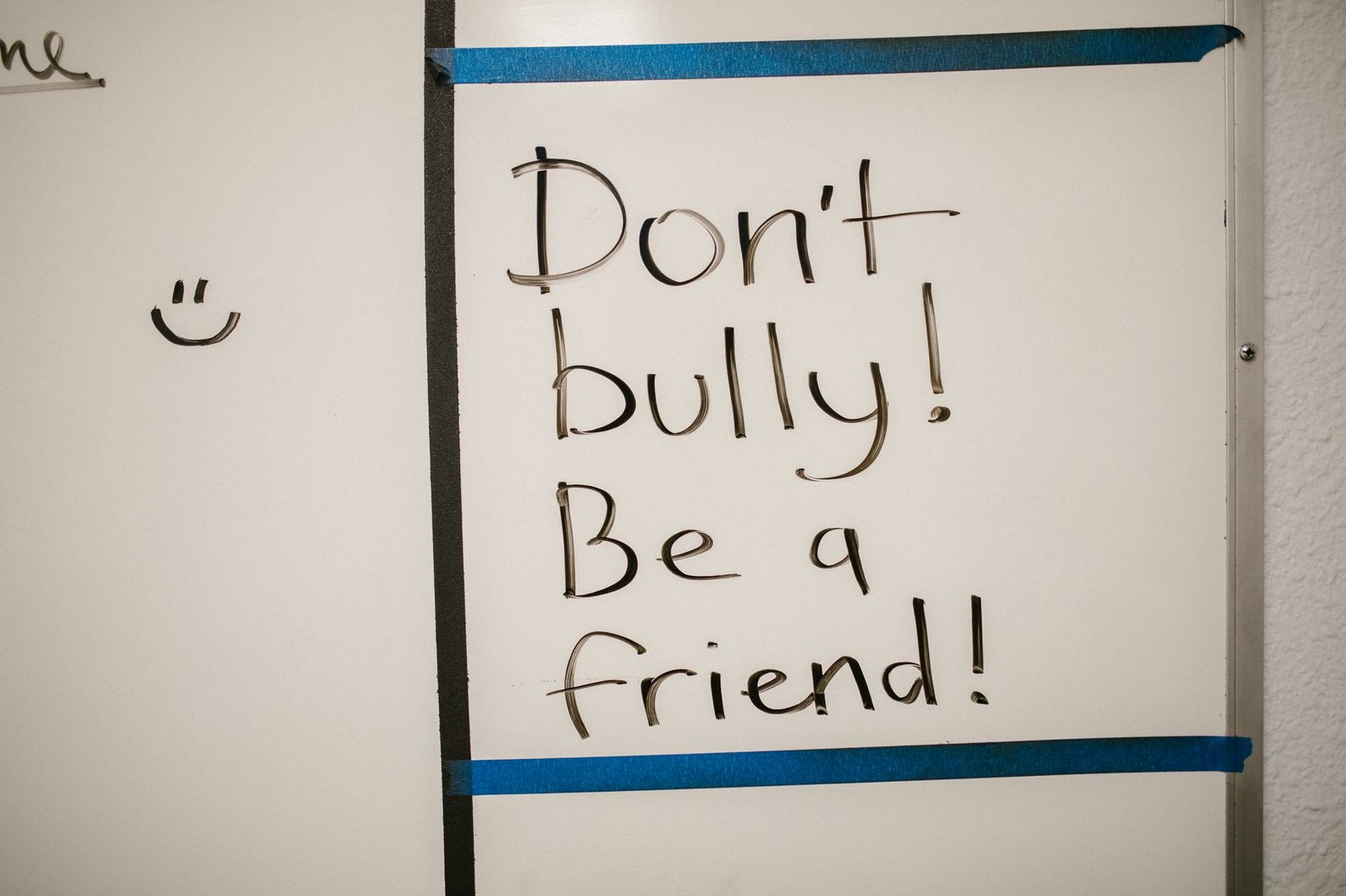 Anti-Bullying and Bullying Prevention Certification - Message against bullying written on a whiteboard, promoting friendship.