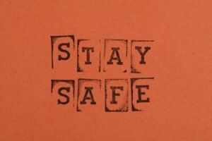 Staying Safe Online Certification - Textured 'Stay Safe' message on an orange background, emphasizing safety and awareness.