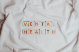 How to Improve Your Mental Health Certification - Close-up of 'Mental Health' text on cloth, symbolizing calmness and self-care.