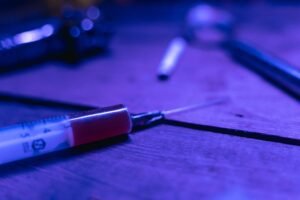 Drug and Alcohol Addiction Awareness Certification - A close-up of a syringe with a dark and moody tone, symbolizing addiction and treatment.