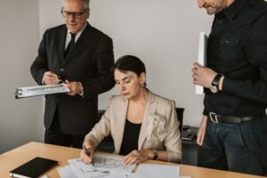 Fraud Awareness - Business professionals collaborating on financial documents in an office setting.