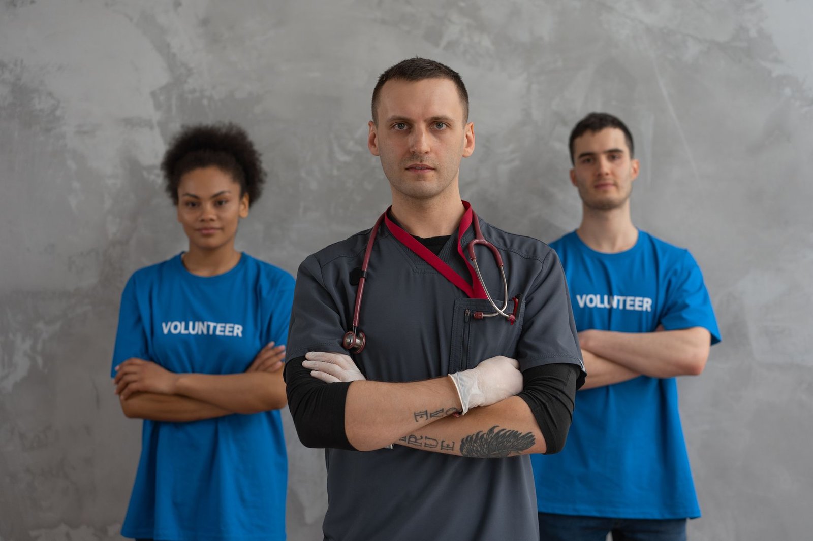 Professional Boundaries in Health and Social Care Certification - Healthcare worker with stethoscope and volunteers standing in solidarity indoors.
