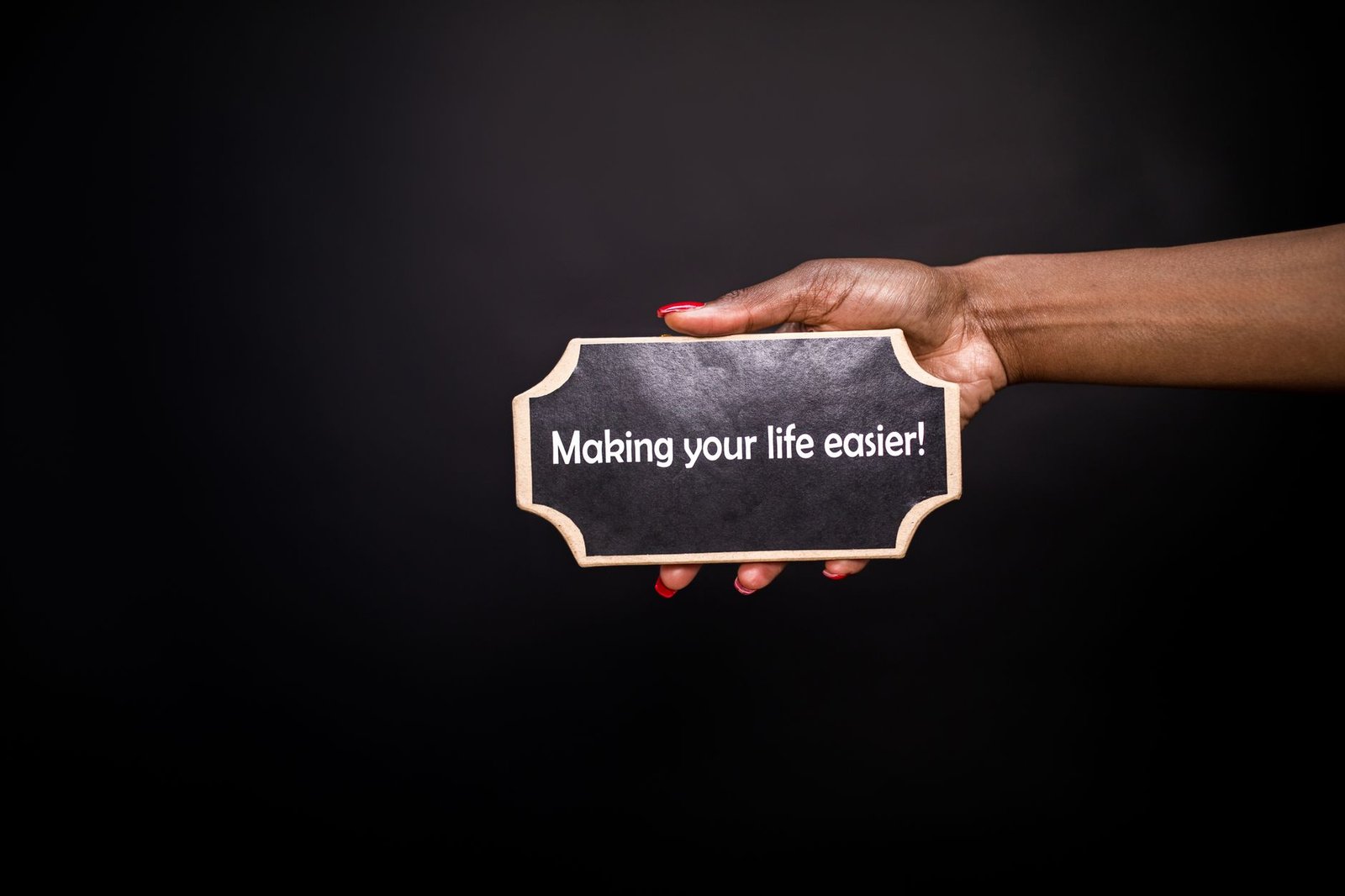 Neuroplasticity: Rewire Your Brain for Success Certification - A hand holding a sign with the quote 'Making your life easier!' against a black background.