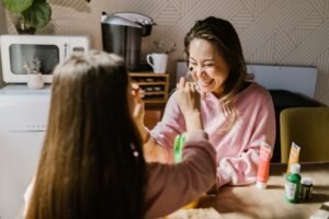 The Science of Happiness Certification - A joyful mother and daughter bonding through arts and crafts at home.