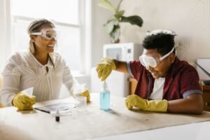 Introduction to The Science of Happiness Certification - A mother and son engaged in a fun and educational science experiment at home, fostering quality family time.