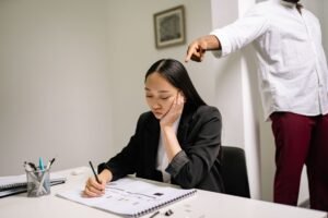 Preventing Workplace Discrimination Certification - An unhappy employee experiencing workplace bullying, depicted by finger pointing in an office setting.