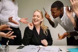 Whistleblowing Training for Employees Certification - Conceptual image of office conflict with a woman facing workplace pressure surrounded by colleagues.