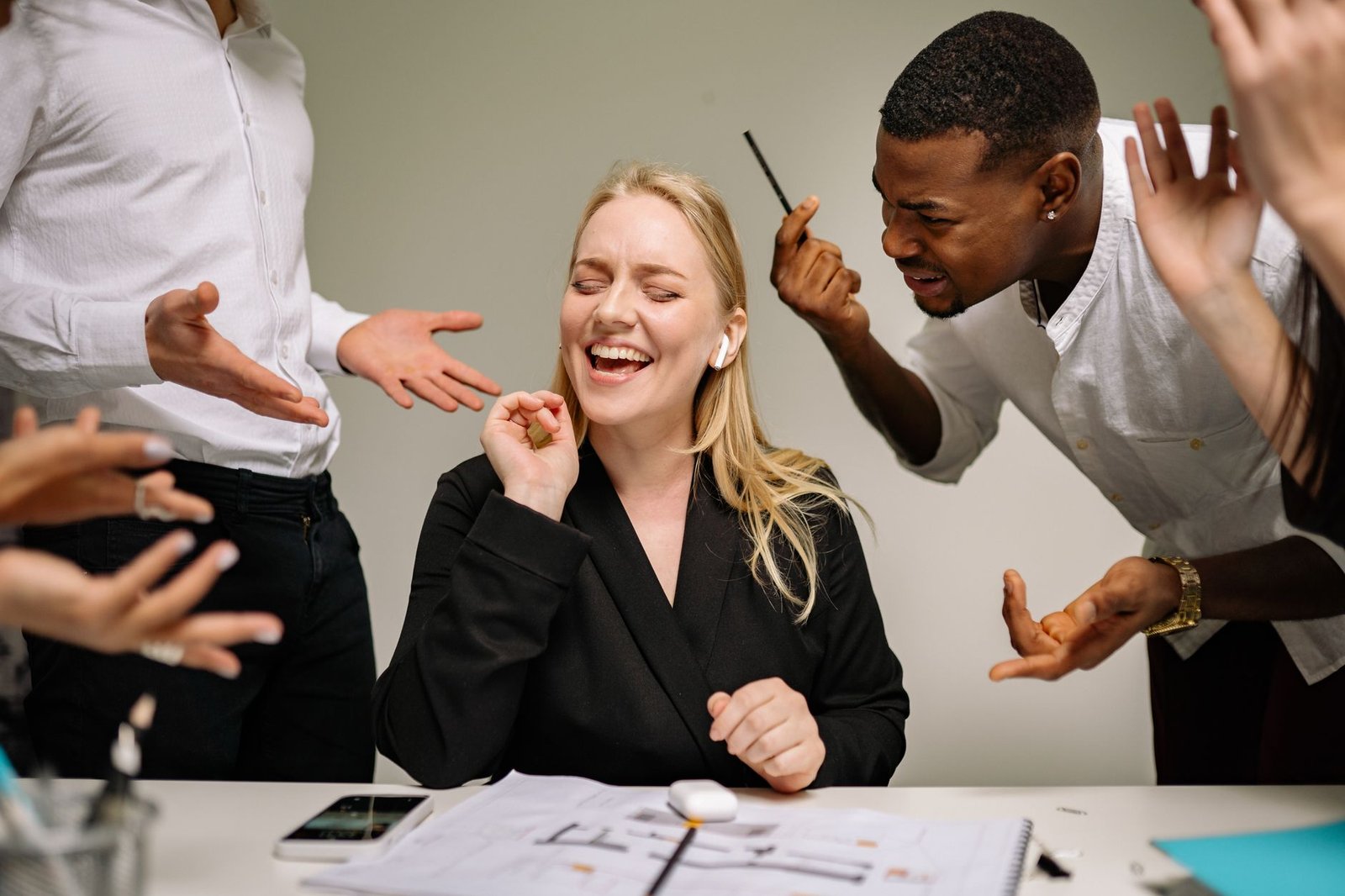 Whistleblowing Training for Employees Certification - Conceptual image of office conflict with a woman facing workplace pressure surrounded by colleagues.
