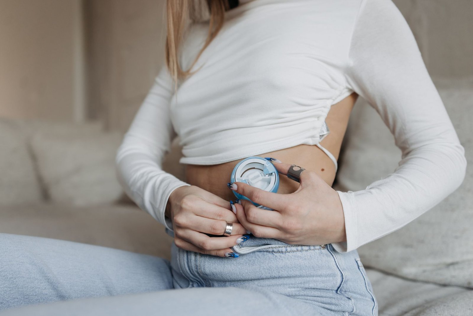 Stoma Care and Management Certification - Close-up of a woman using an insulin pump, highlighting diabetes management.