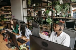 Customer Relationship Management Certification - A diverse team collaborates in a modern office with plants and technology.