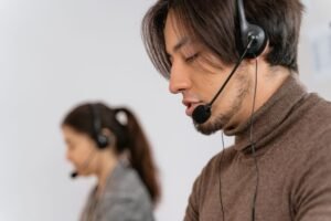 Customer Services Certification Level 3 - Focused call center employees wearing headsets, assisting customers with exceptional service.
