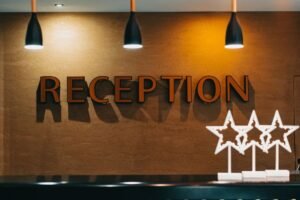 Hotel Reception Certification - Elegant hotel reception area with illuminated signage and decor.