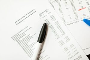 Cash Flow Statements and Logistics Certification - Financial documents featuring cash flows and pens, ideal for business themes and analysis.