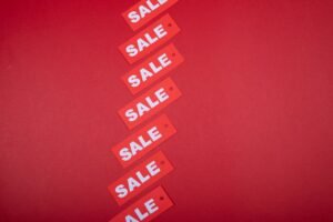 Sales Talk – Understanding the Jargon Certification - Red sale tags aligned diagonally on a red background, perfect for retail promotions.
