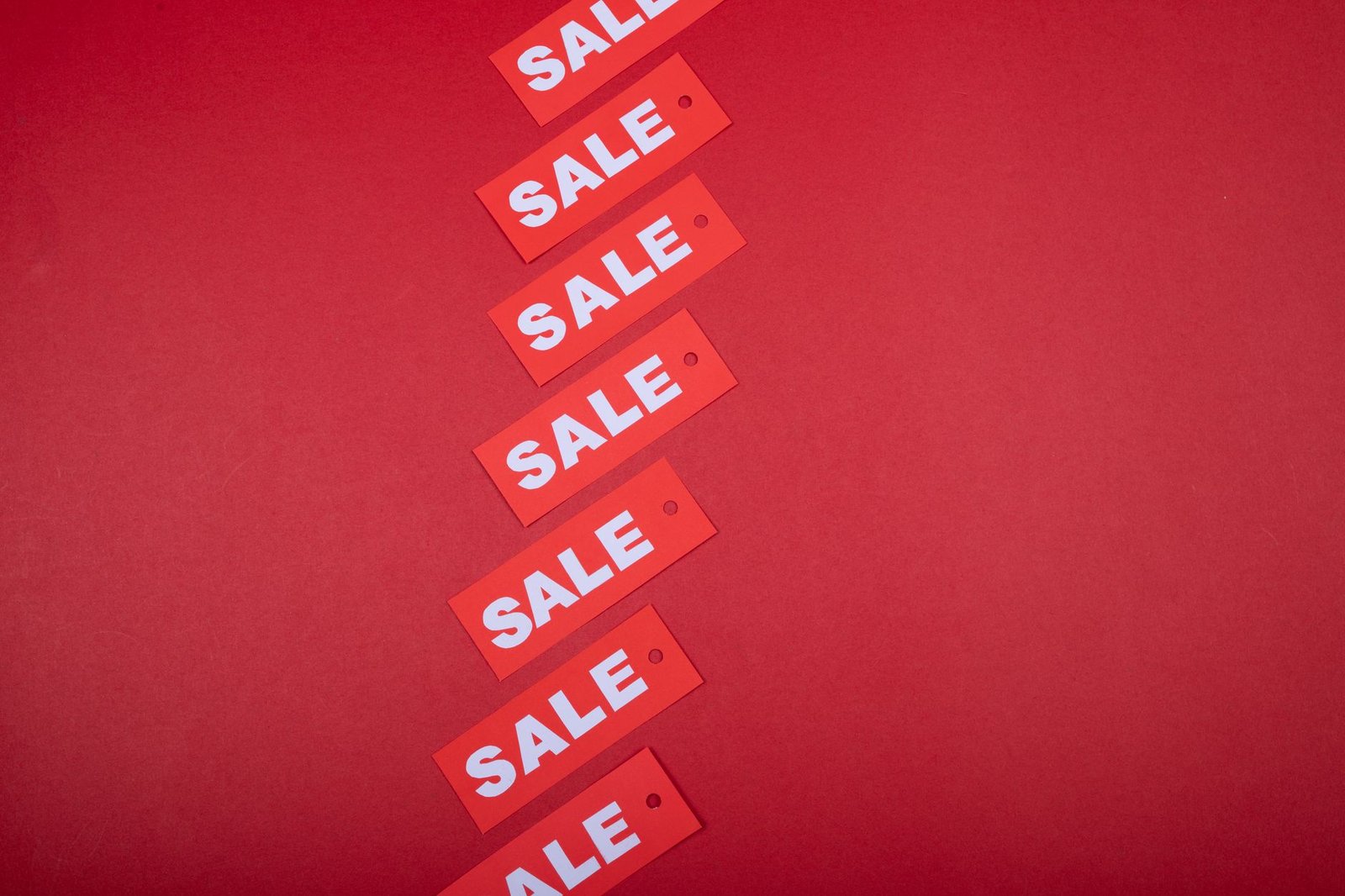 Sales Talk – Understanding the Jargon Certification - Red sale tags aligned diagonally on a red background, perfect for retail promotions.