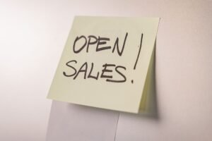 How to Close More Sales Certification - A close-up of an 'Open Sales' sticky note on a white background, ideal for business promotions.