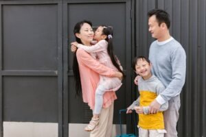 Parental Rights Certification - Asian family embracing and enjoying time together outdoors, showcasing love and inclusion.