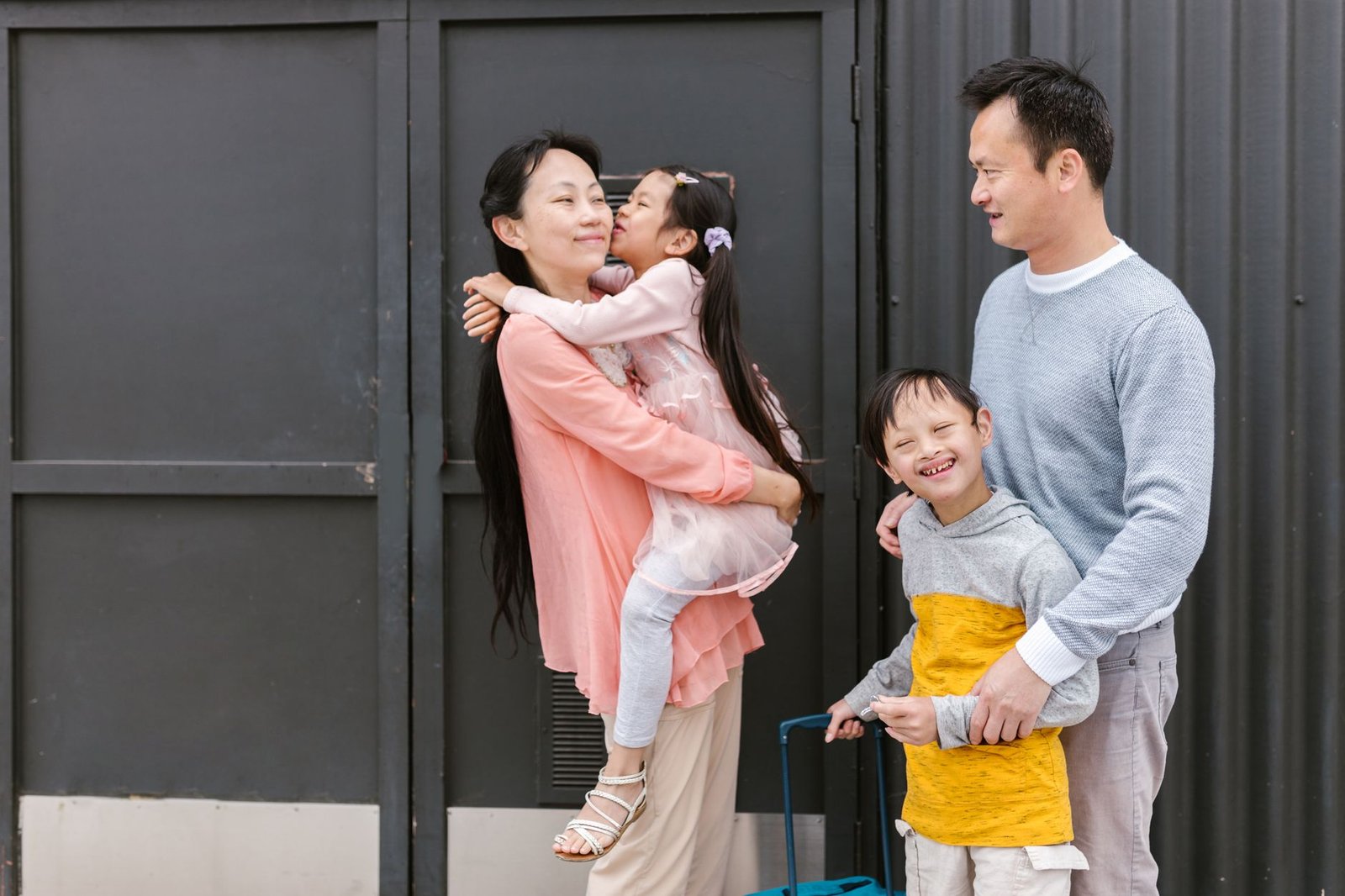 Parental Rights Certification - Asian family embracing and enjoying time together outdoors, showcasing love and inclusion.