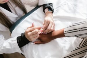 Medical Acupuncture Certification - Close-up of a professional performing acupuncture therapy on a client's hand for wellness.