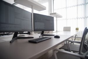 Display Screen Equipment Awareness Certification - Stylish contemporary office featuring multiple computer monitors and ergonomic chairs.