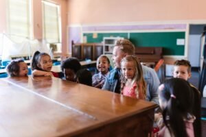 EYFS Teaching Certification Level 3 - A group of children and a teacher enjoying a playful learning session in a classroom setting.