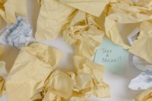 Tackling Procrastination Certification - Crumpled papers scattered around with a note reading 'Take a Break'.