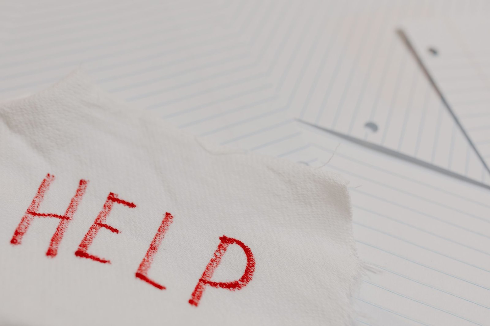 The HMT Sanctions List Certification - A raw and emotional depiction of a plea for help written on torn paper amidst lined sheets.