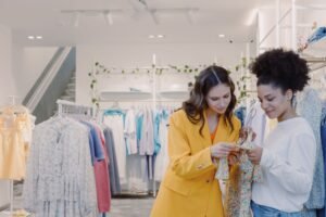 Identifying and Exceeding Customer Expectations Certification - Two women browsing clothes in a stylish, modern boutique.