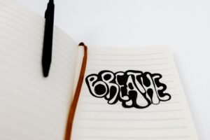 Journalling for Wellbeing Certificate - Handwritten 'Breathe' in a notebook, encouraging relaxation and mindfulness.