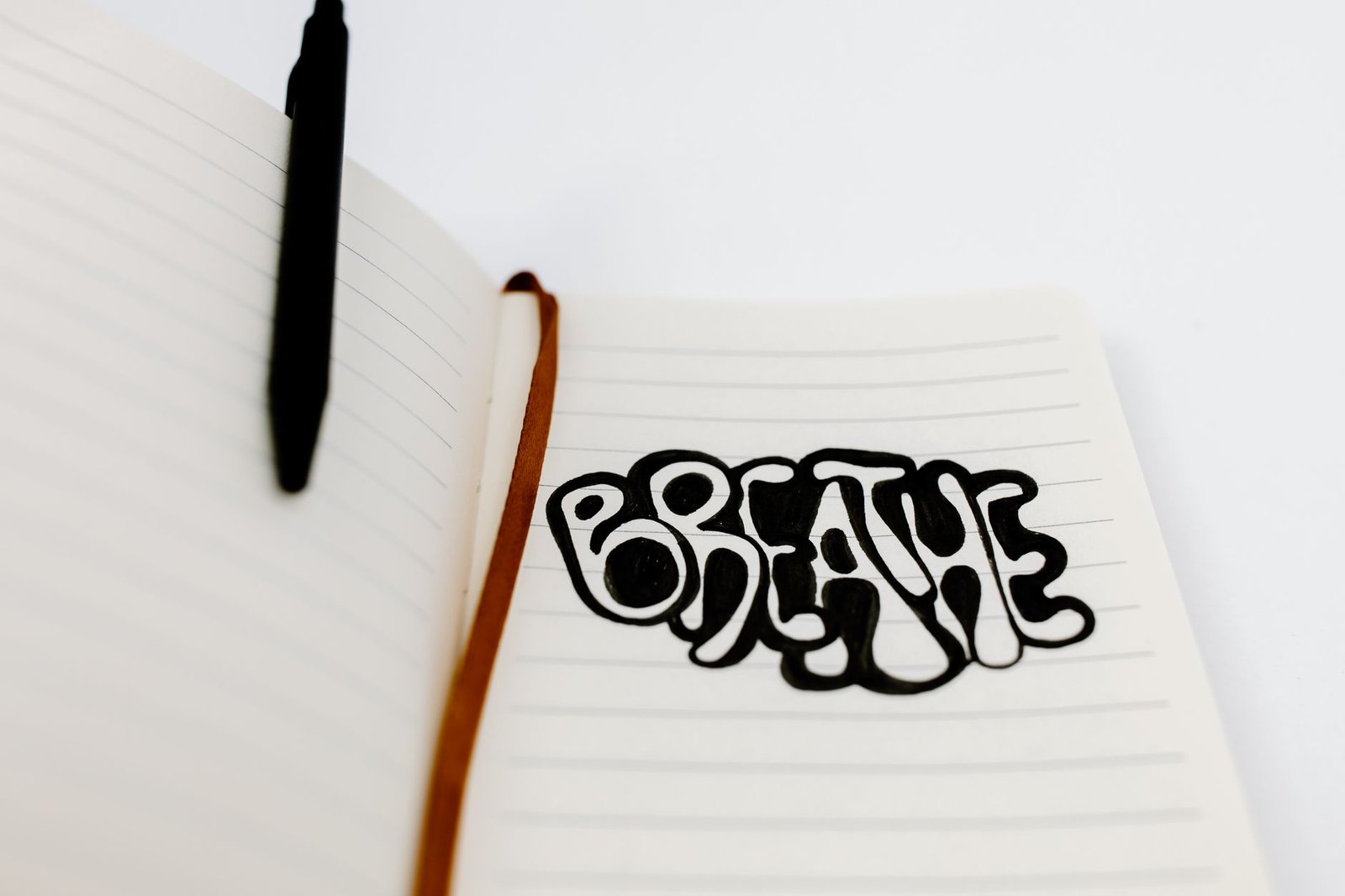 Journalling for Wellbeing Certificate - Handwritten 'Breathe' in a notebook, encouraging relaxation and mindfulness.