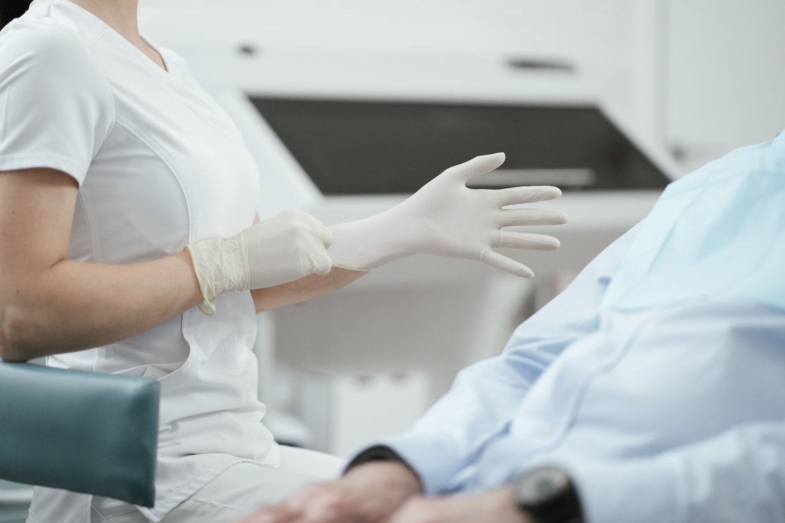 Infection Control Certification - Close-up of a healthcare worker putting on sterile gloves before examining a patient.