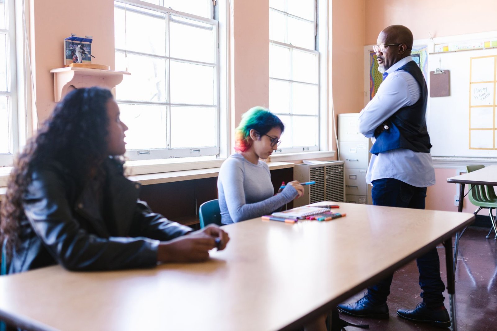 Mental Health Training for Teachers Certification - Teacher and students engaged in a classroom discussion with natural light.