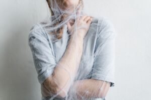 Anxiety Awareness Certification - A woman metaphorically trapped in a spider web depicting anxiety and entrapment.