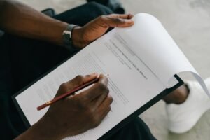 Assessing Mental Capacity Certification - Close-up of a person writing on a psychological assessment form with a pencil.