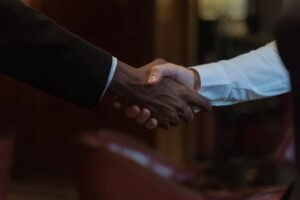 Negotiation Skills Certification - Close-up of a diverse handshake, representing business collaboration and diversity.