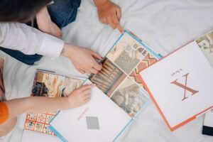 Home Education Certification - Top view of children exploring colorful illustrated books, fostering learning and interaction.