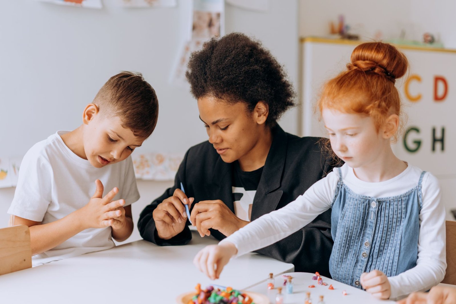 Nursery Assistant Certification - Teacher engaging with children in a classroom setting, fostering learning and creativity.