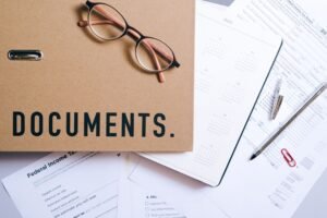 Financial Documents 101 Certification - Flat lay of office supplies including documents, calendar, and eyeglasses on a desk.